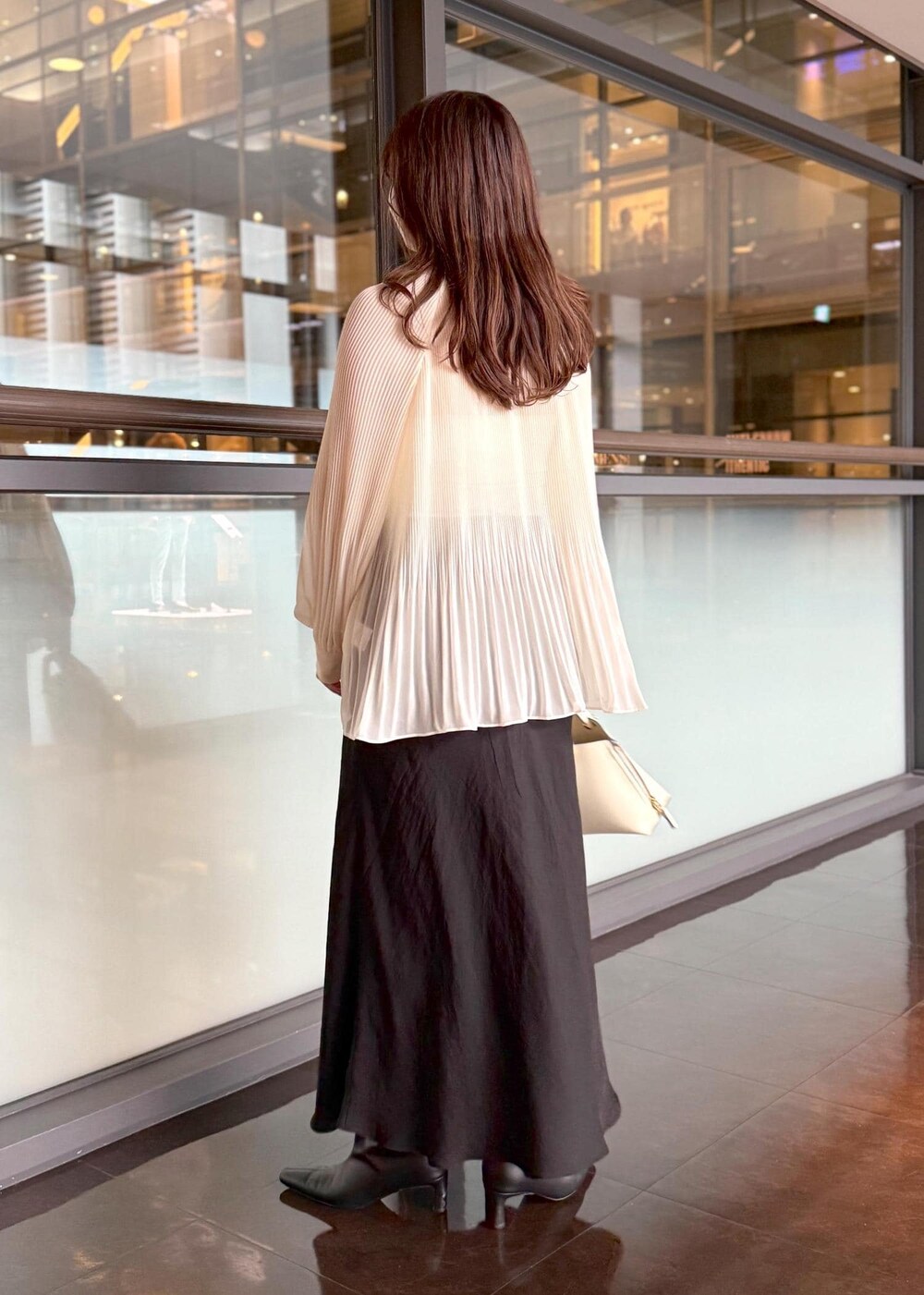 ホワイト系のハンドバッグ、ブラック系のスカート、ホワイト系のシャツ/ブラウスを着用したレディースの秋コーディネートの8枚目の写真