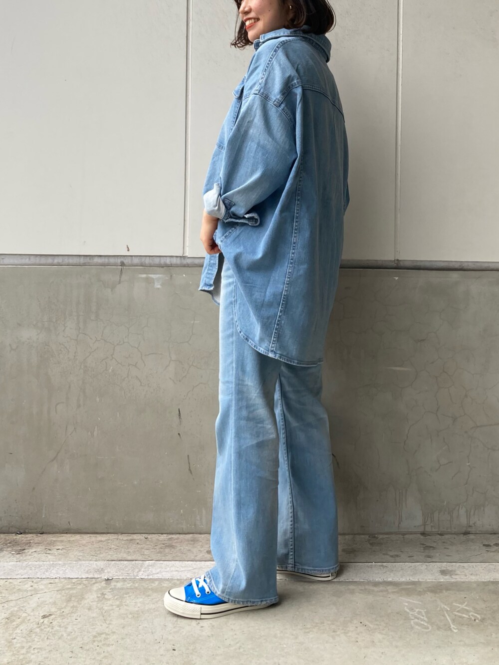 ブルー系のシャツ/ブラウス、ブルー系のデニムパンツ、ブラック系のトートバッグを着用したレディースの冬コーディネートの2枚目の写真