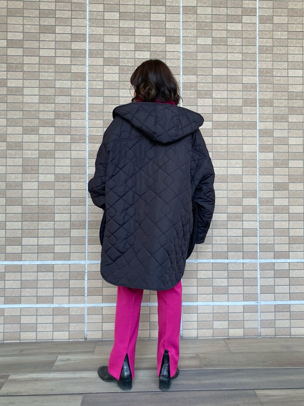 ブラック系のダウンジャケット/コート、ベージュ系のニット/セーター、ピンク系のその他パンツを着用したレディースの冬コーディネートの3枚目の写真