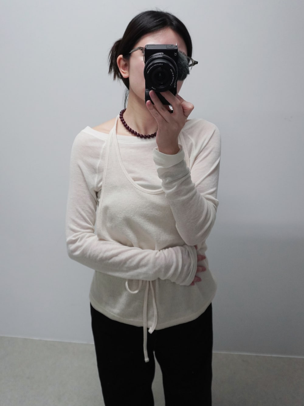 ブラック系のデニムパンツ、ホワイト系のTシャツ/カットソー、ブラック系のローファーを着用したレディースの冬コーディネートの2枚目の写真