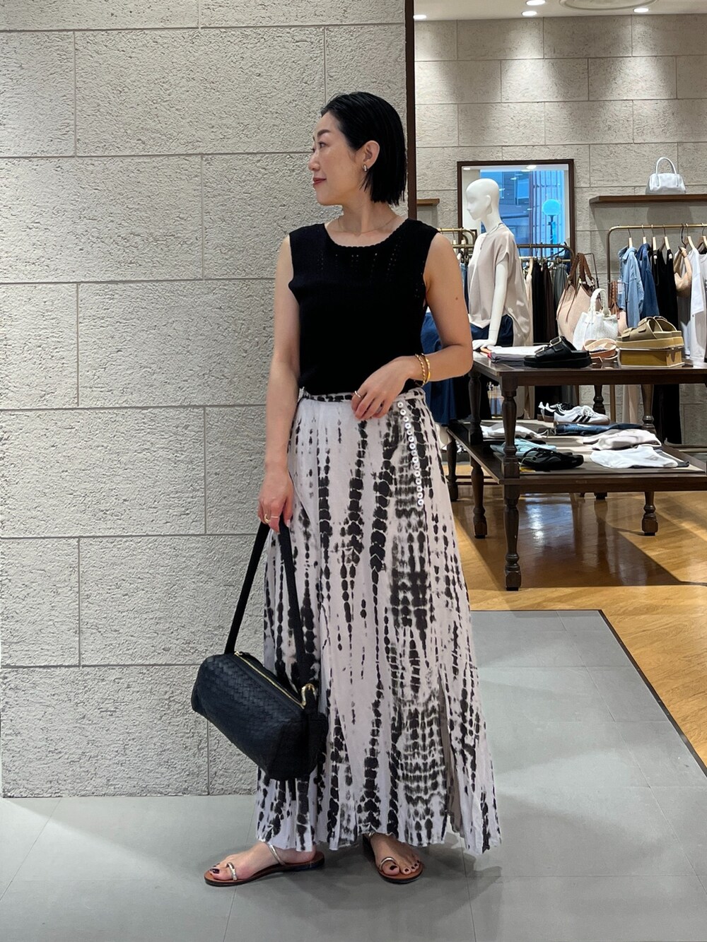 ブラック系のニット/セーター、ブラック系のスカート、ブラック系のベストを着用したレディースの夏コーディネートの3枚目の写真