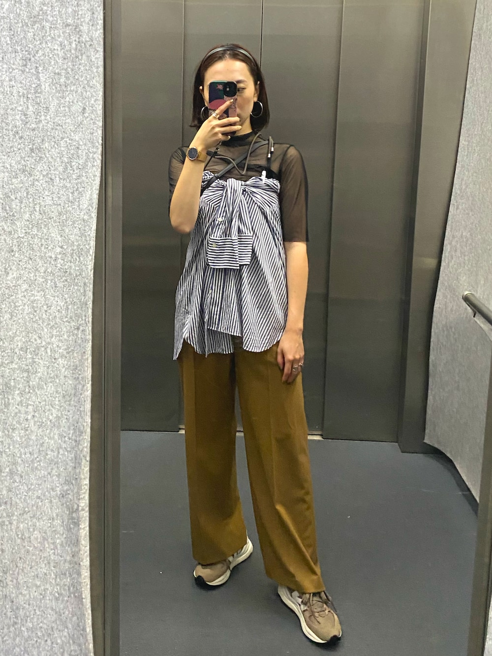 ブルー系のシャツ/ブラウス、オレンジ系のパンツ、ベージュ系のスニーカーを着用したレディースの夏コーディネートの4枚目の写真