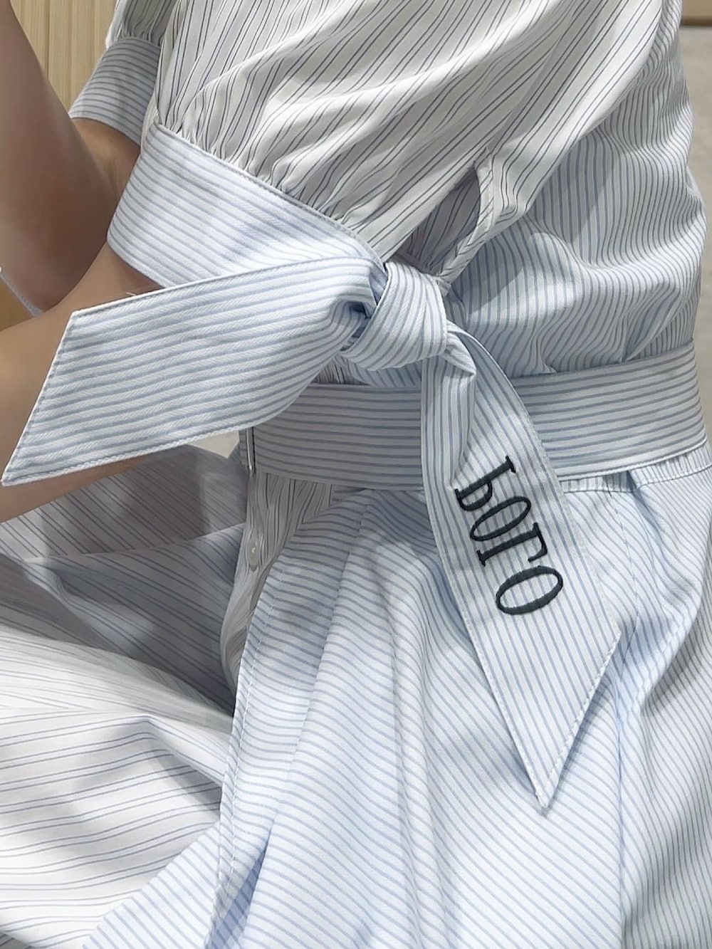 ブルー系のワンピースを着用したレディースの春コーディネートの5枚目の写真