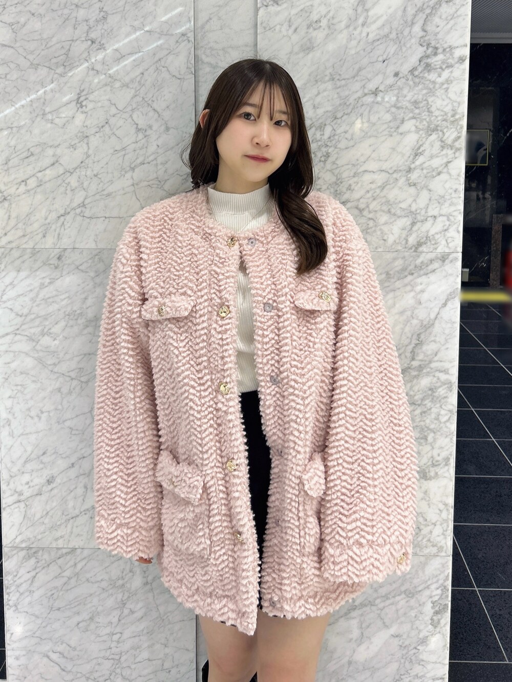 ピンク系のブルゾン、ブラック系のその他パンツ、ホワイト系のニット/セーターを着用したレディースの秋コーディネートの6枚目の写真