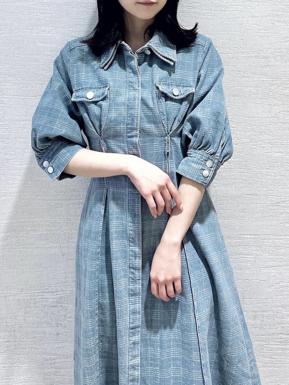 ブルー系のワンピース、ホワイト系のブーツを着用したレディースの冬コーディネートの6枚目の写真