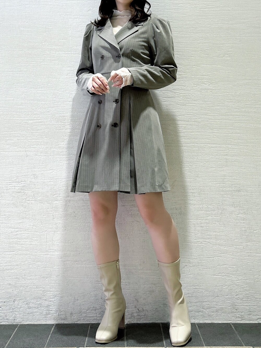 グレー系のワンピース、ホワイト系のTシャツ/カットソー、ホワイト系のブーツを着用したレディースの秋コーディネートの4枚目の写真