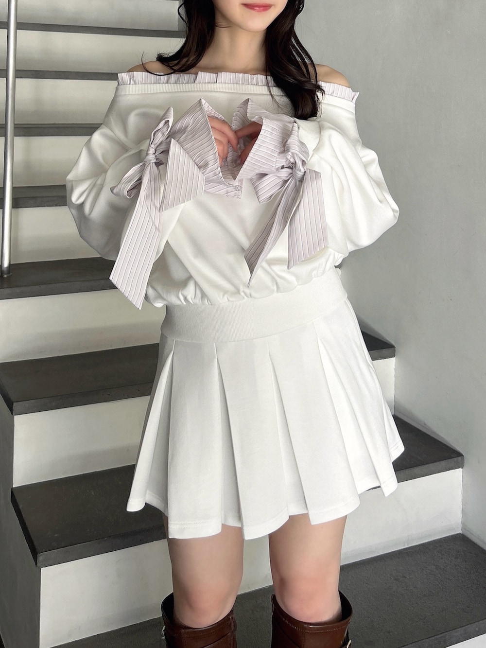 ホワイト系のTシャツ/カットソー、ホワイト系のスカート、ブラウン系のブーツを着用したレディースの春コーディネートの9枚目の写真