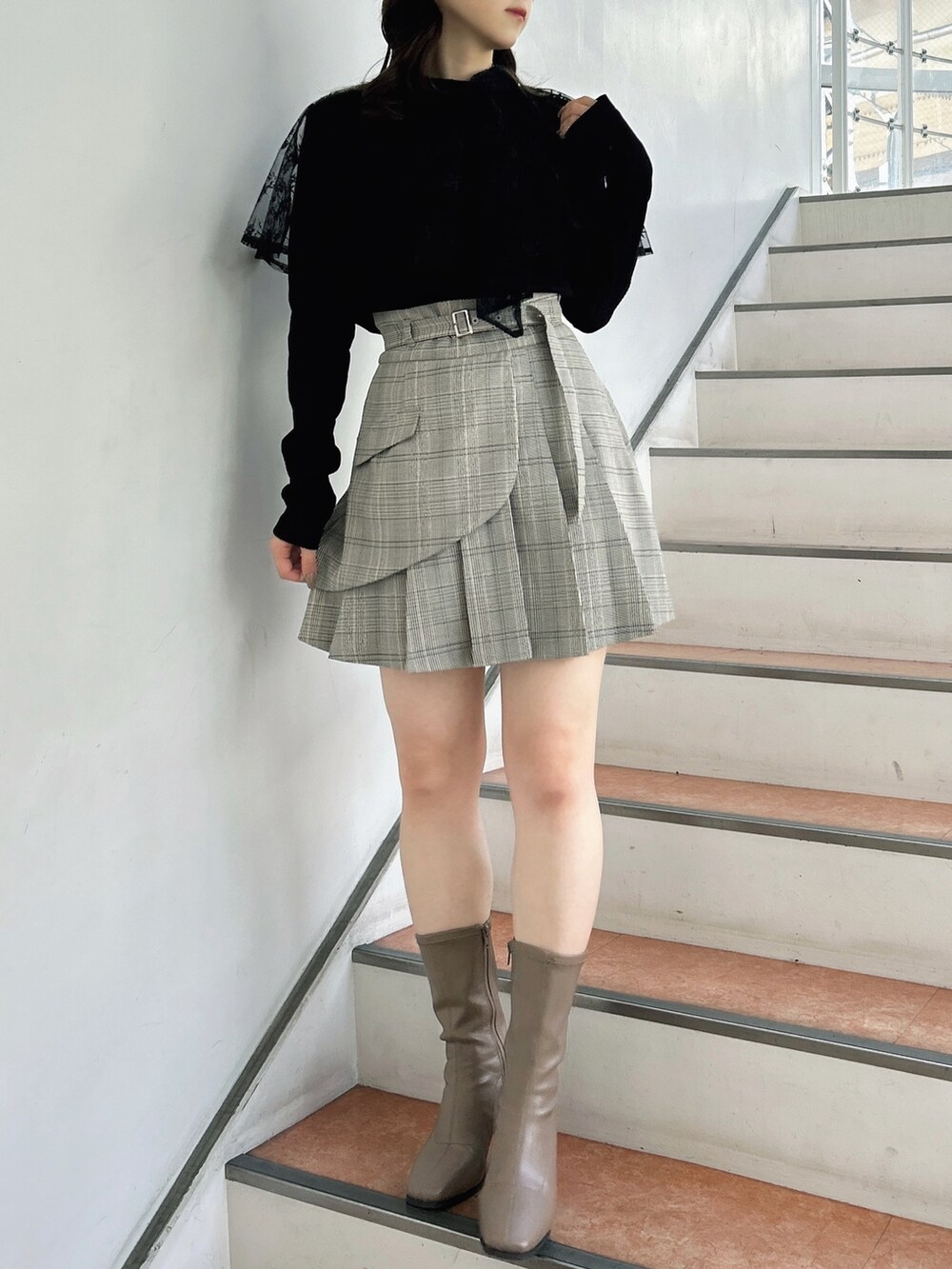 その他のスカート、ベージュ系のブーツ、ブラック系のTシャツ/カットソーを着用したレディースの秋コーディネートの2枚目の写真