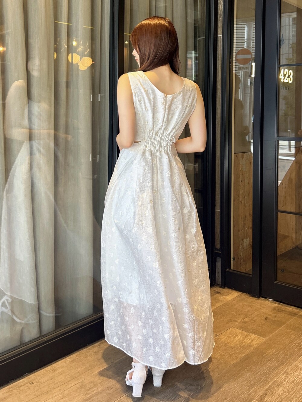 ホワイト系のワンピース、ホワイト系のサンダルを着用したレディースの秋コーディネートの5枚目の写真