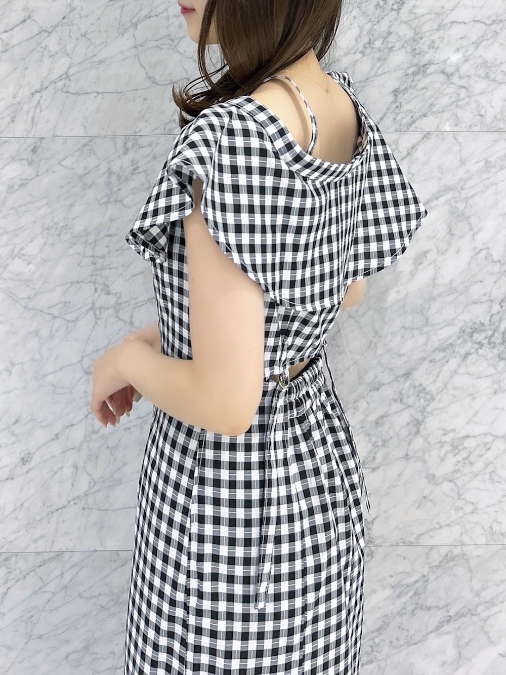 ホワイト系のパンプス、ブラック系のワンピースを着用したレディースの夏コーディネートの7枚目の写真