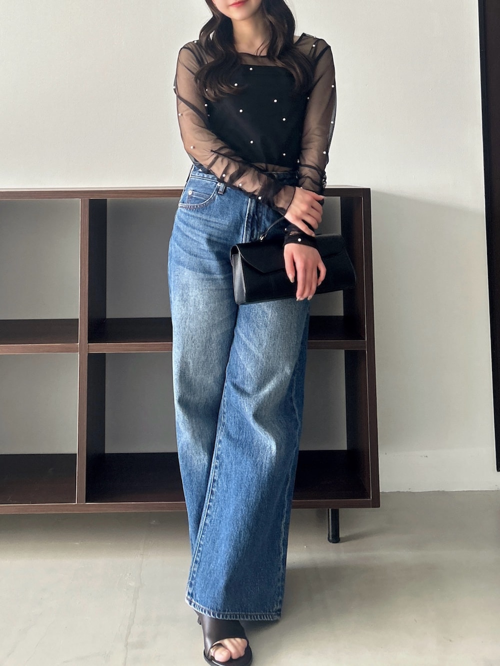ブラック系のTシャツ/カットソー、ブルー系のデニムパンツを着用したレディースの春コーディネートの3枚目の写真