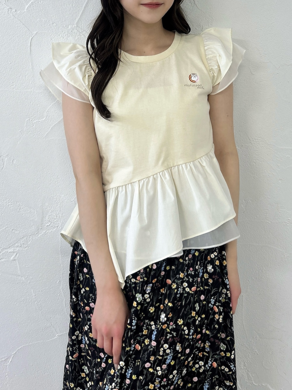 ベージュ系のTシャツ/カットソー、ブラック系のスカート、ホワイト系のサンダルを着用したレディースの春コーディネートの7枚目の写真