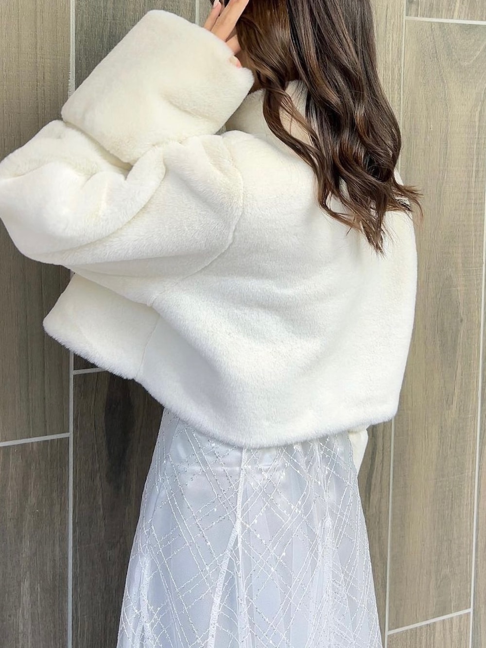 ホワイト系のその他アウター、ホワイト系のブーツ、ホワイト系のニット/セーターを着用したレディースの冬コーディネートの10枚目の写真