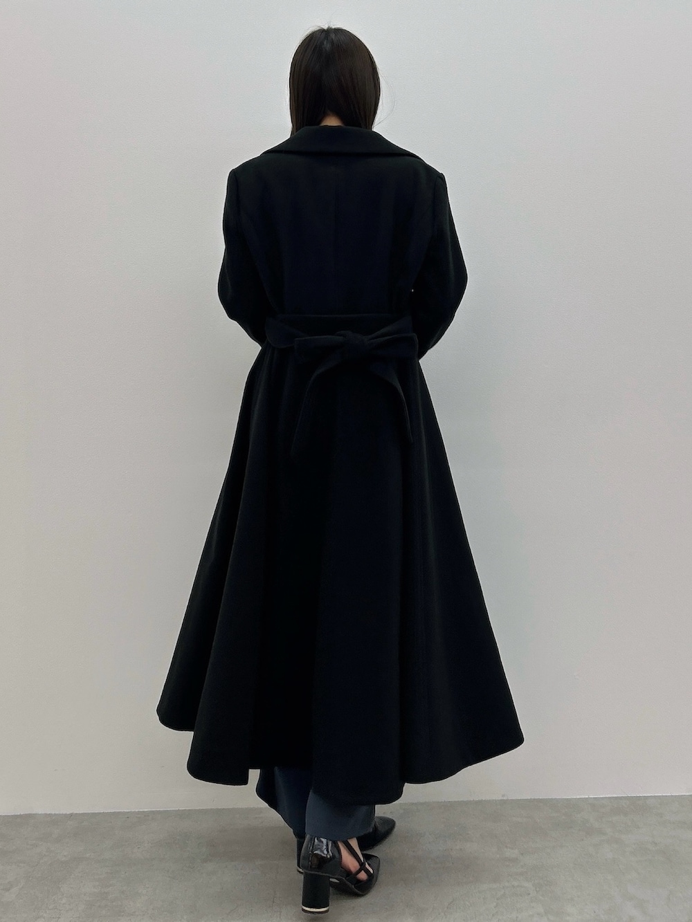 ブラック系のその他アウター、ピンク系のニット/セーター、グレー系のその他パンツを着用したレディースの冬コーディネートの5枚目の写真