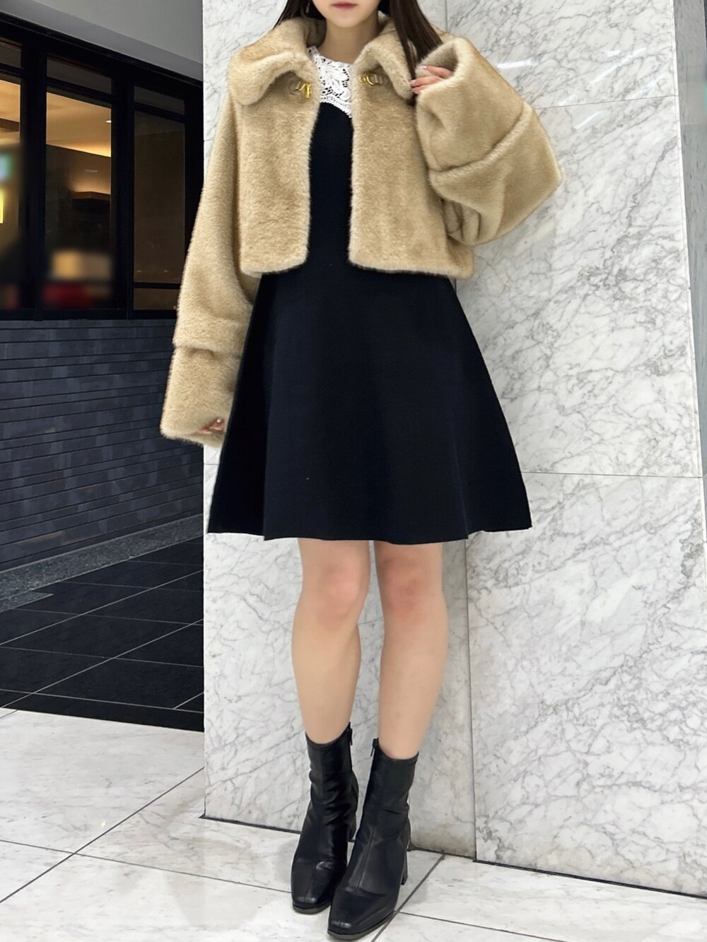 ブラウン系のその他アウター、ブラック系のワンピース、ブラック系のブーツを着用したレディースの冬コーディネートの2枚目の写真