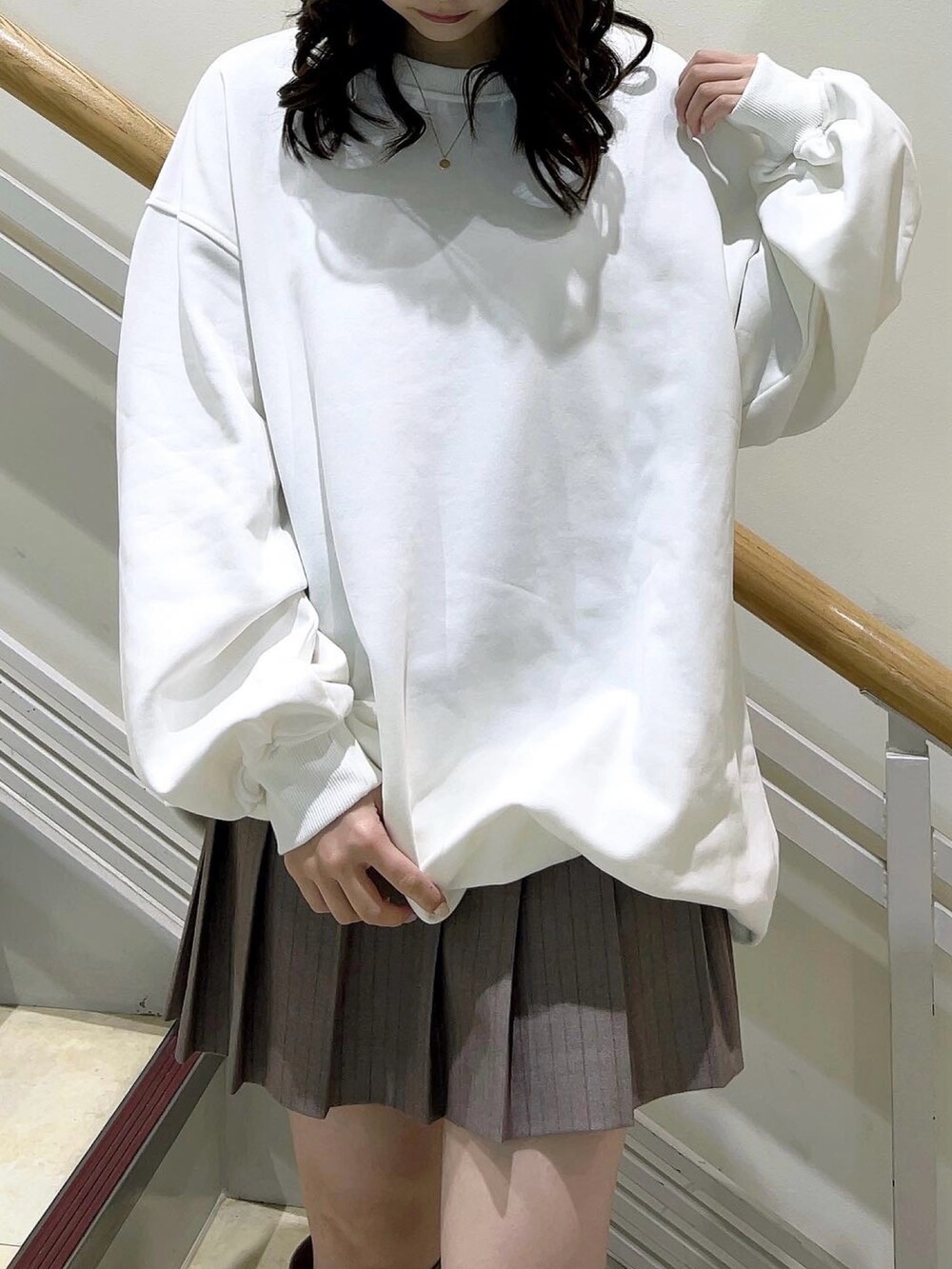 ホワイト系のTシャツ/カットソー、ベージュ系のスカート、ベージュ系のブーツを着用したレディースの冬コーディネートの6枚目の写真