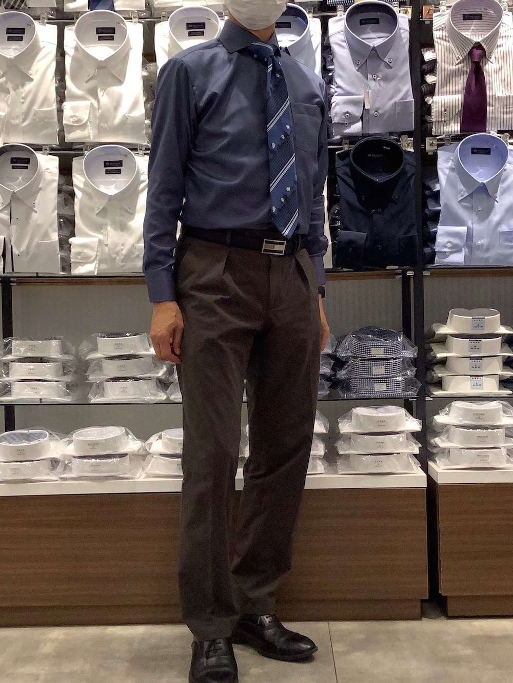 ブルー系のビジネスシャツ、グレー系のベスト、ブラック系のベルトを着用したメンズの秋コーディネートの2枚目の写真