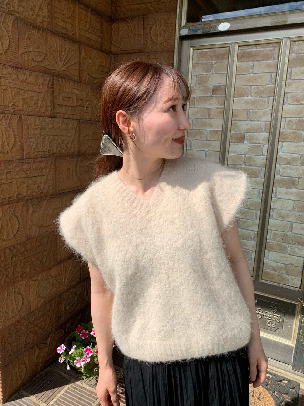 ホワイト系のニット/セーター、ブラック系のスカートを着用したレディースの夏コーディネートの2枚目の写真