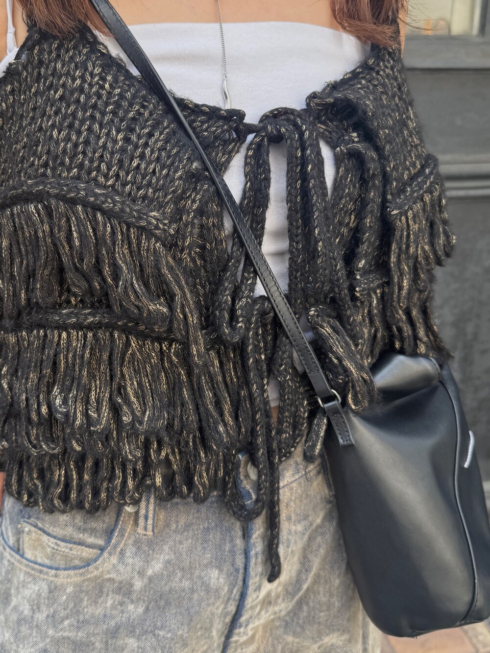 ベージュ系のデニムパンツ、ブラック系のニット/セーター、ベージュ系のスリッポンを着用したレディースの秋コーディネートの9枚目の写真