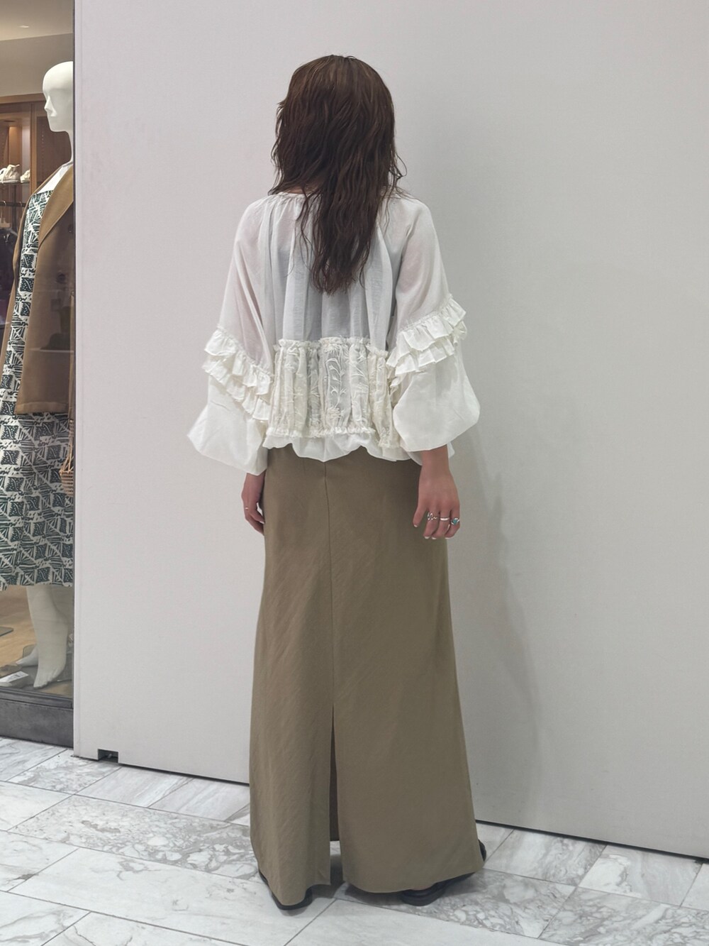 ベージュ系のスカート、ホワイト系のシャツ/ブラウス、ブラック系のキャミソールを着用したレディースの春コーディネートの4枚目の写真