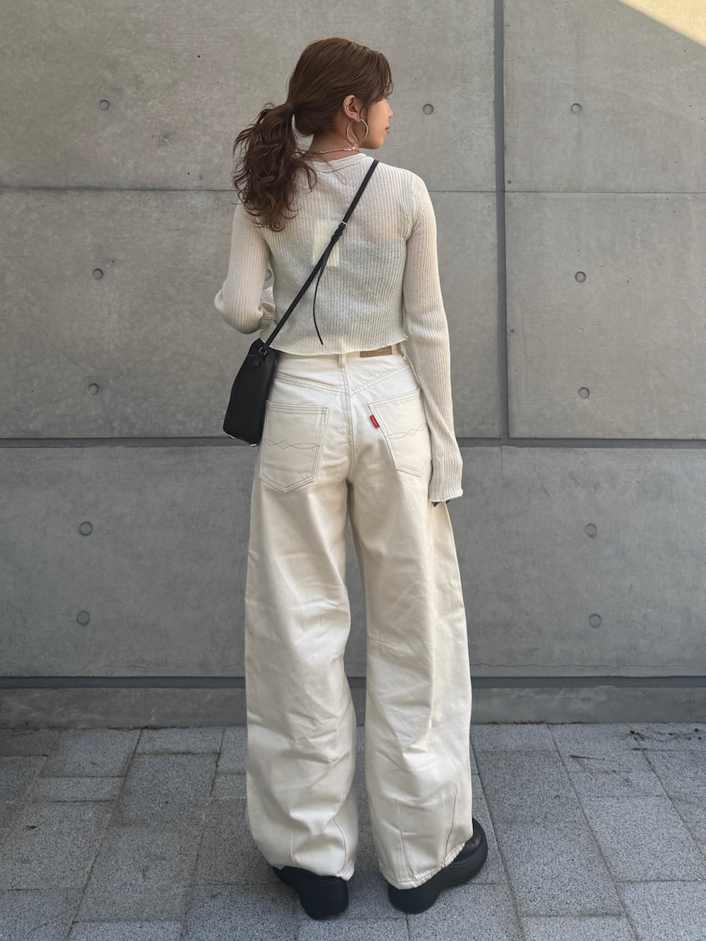 ホワイト系のカーディガン/ボレロ、ホワイト系のデニムパンツを着用したレディースの春コーディネートの4枚目の写真