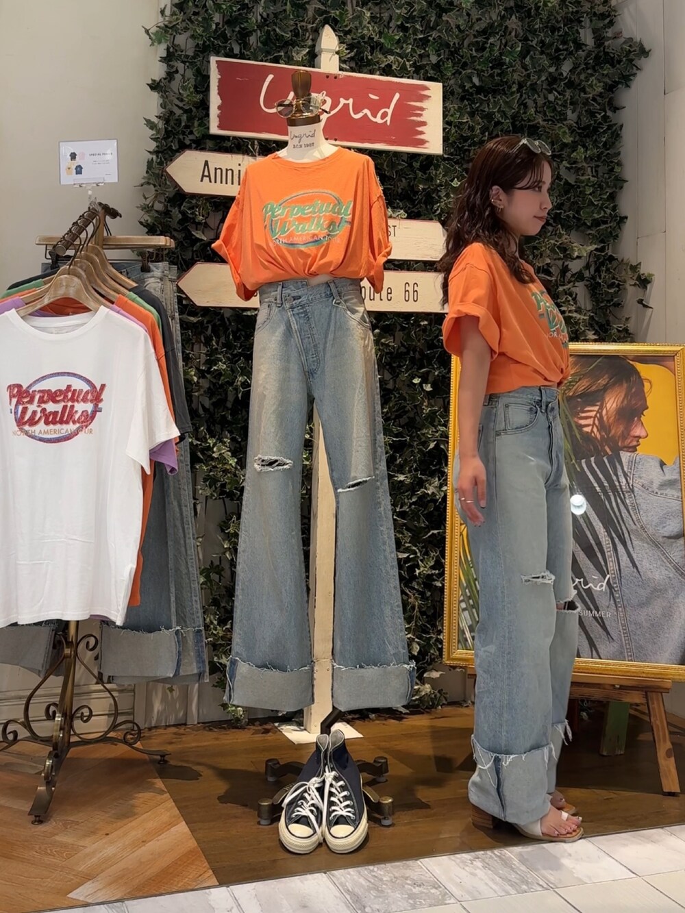 ブルー系のデニムパンツ、オレンジ系のTシャツ/カットソー、ホワイト系のサンダルを着用したレディースの夏コーディネートの5枚目の写真