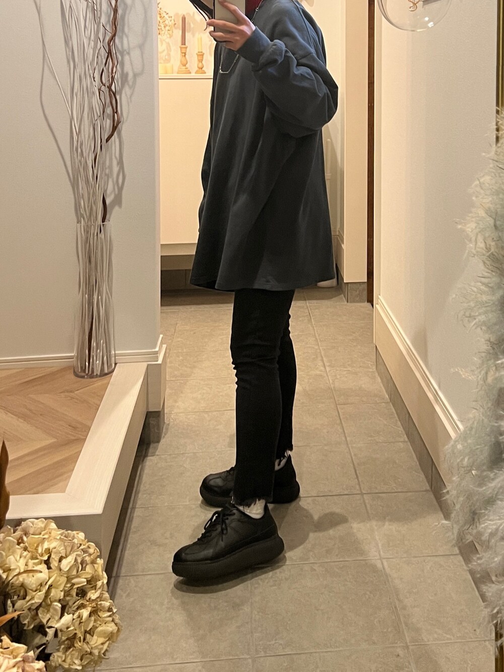 グレー系のTシャツ/カットソー、レッド系のニット/セーター、ブラック系のデニムパンツを着用したレディースの冬コーディネートの3枚目の写真