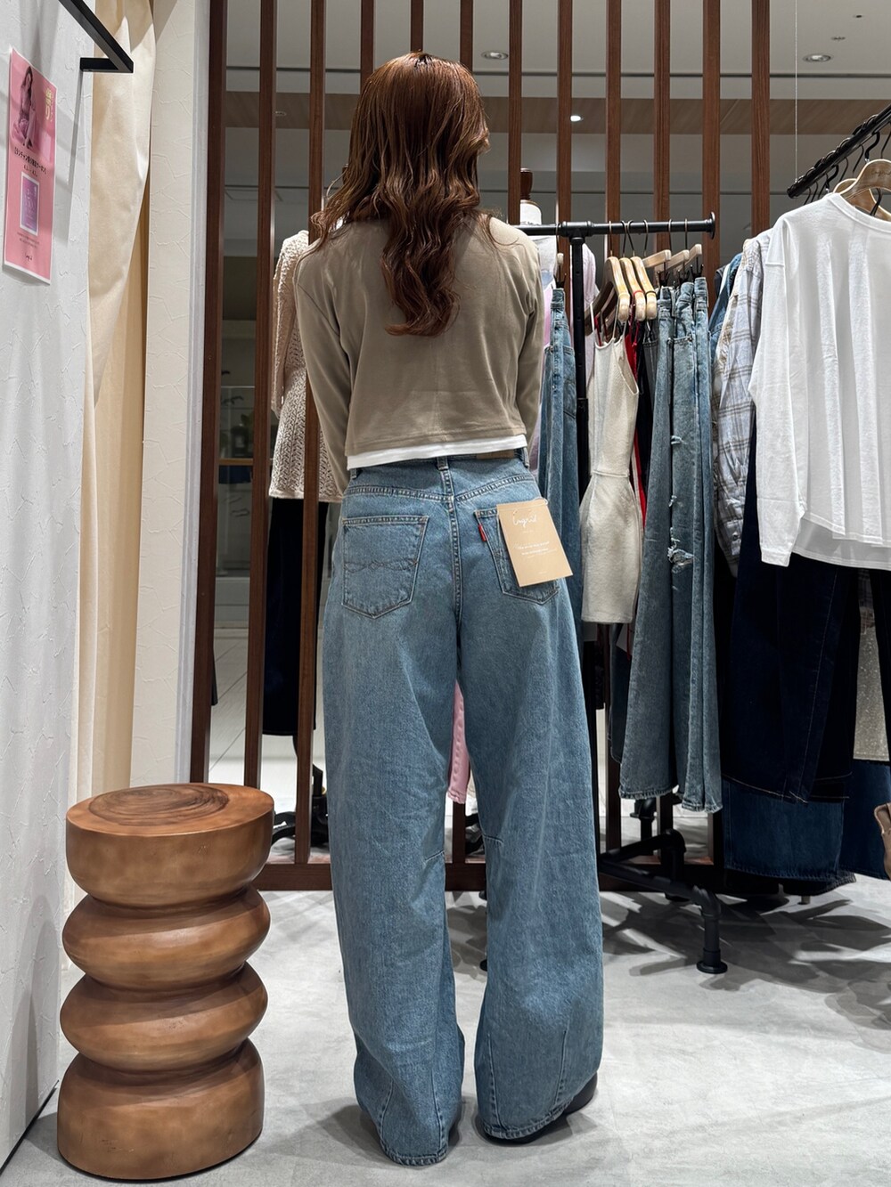 ブルー系のデニムパンツ、ベージュ系のTシャツ/カットソーを着用したレディースの春コーディネートの3枚目の写真