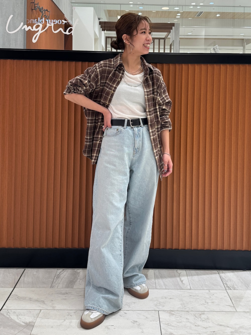 ホワイト系のTシャツ/カットソー、ブラウン系のシャツ/ブラウス、ブルー系のデニムパンツを着用したレディースの冬コーディネートの2枚目の写真