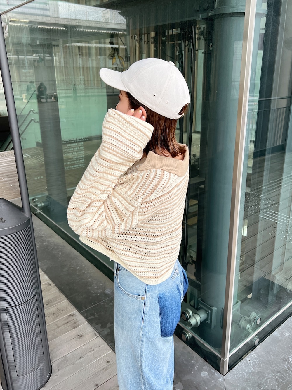 ベージュ系のニット/セーター、ブルー系のデニムパンツ、ホワイト系のサンダルを着用したレディースの春コーディネートの9枚目の写真