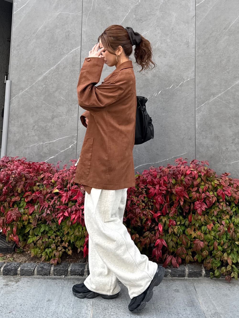 ブラウン系のテーラードジャケット、ホワイト系のスウェットパンツを着用したレディースの冬コーディネートの3枚目の写真