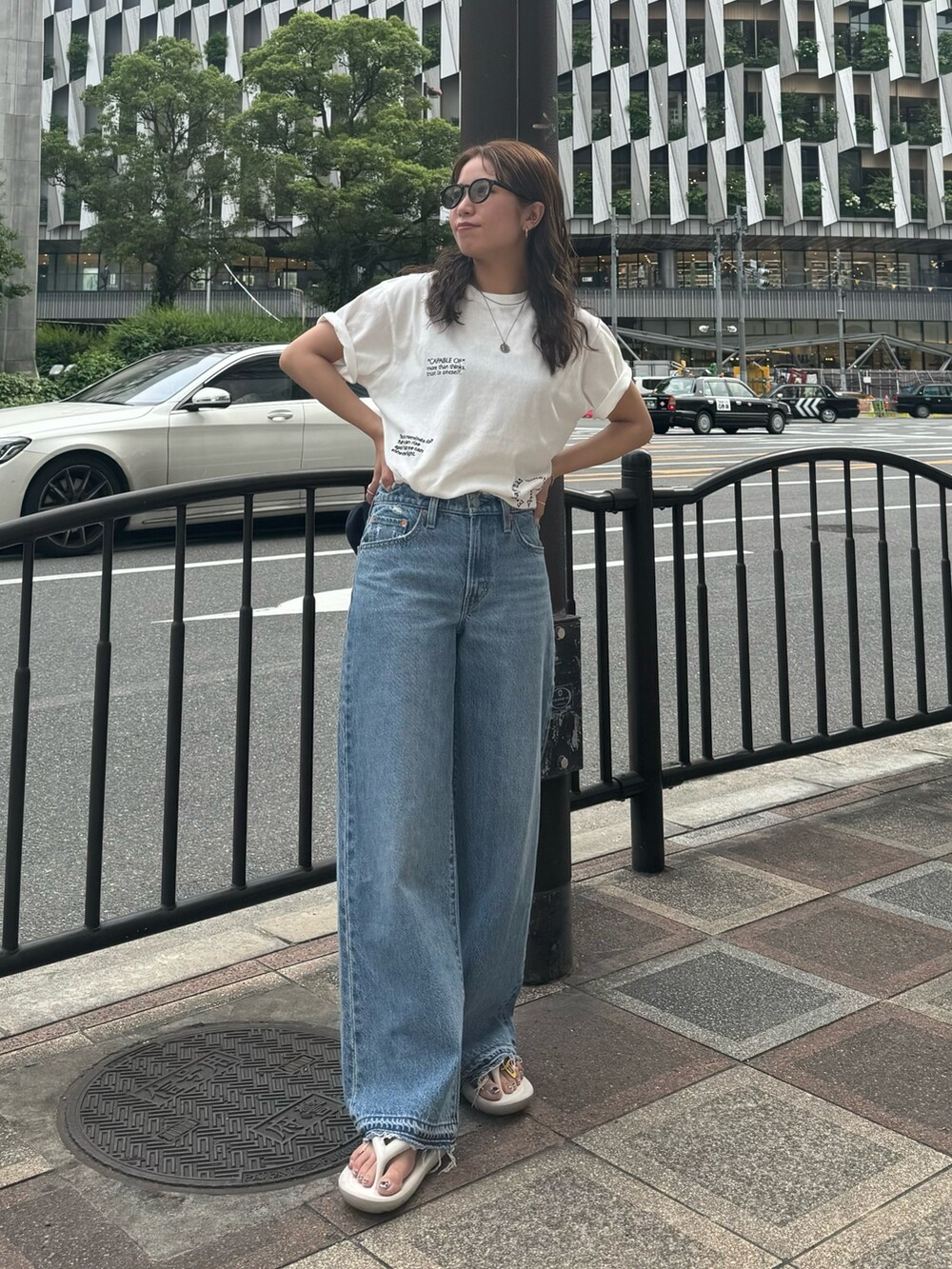 ホワイト系のTシャツ/カットソー、ブルー系のデニムパンツを着用したレディースの夏コーディネートの2枚目の写真