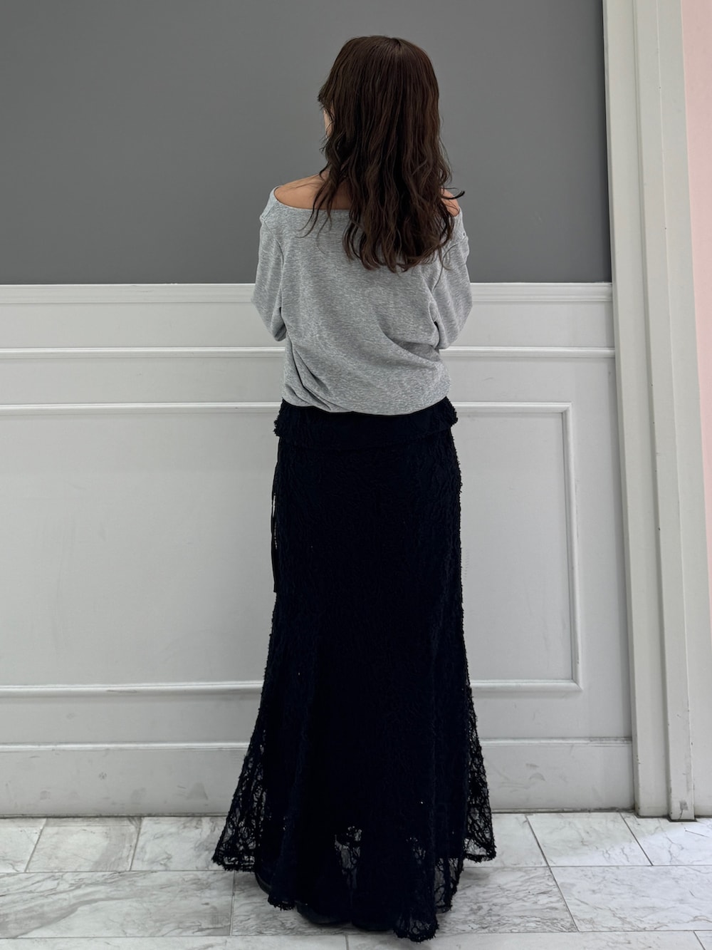 グレー系のTシャツ/カットソー、ブラック系のスカートを着用したレディースの冬コーディネートの4枚目の写真