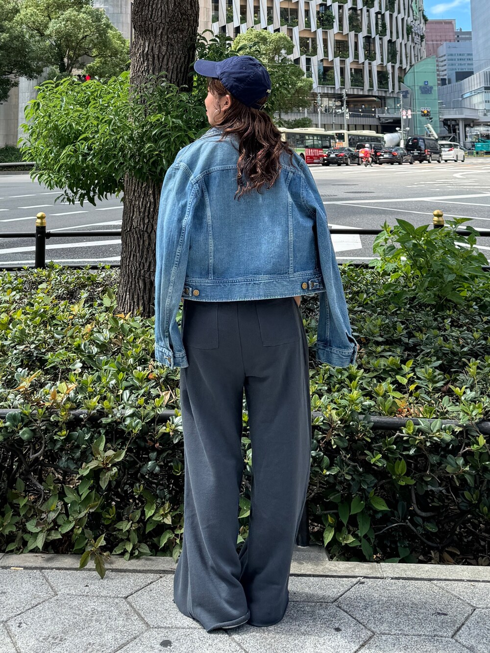 グレー系のスウェットパンツ、ブルー系のデニムジャケット、パープル系のスウェットを着用したレディースの秋コーディネートの4枚目の写真