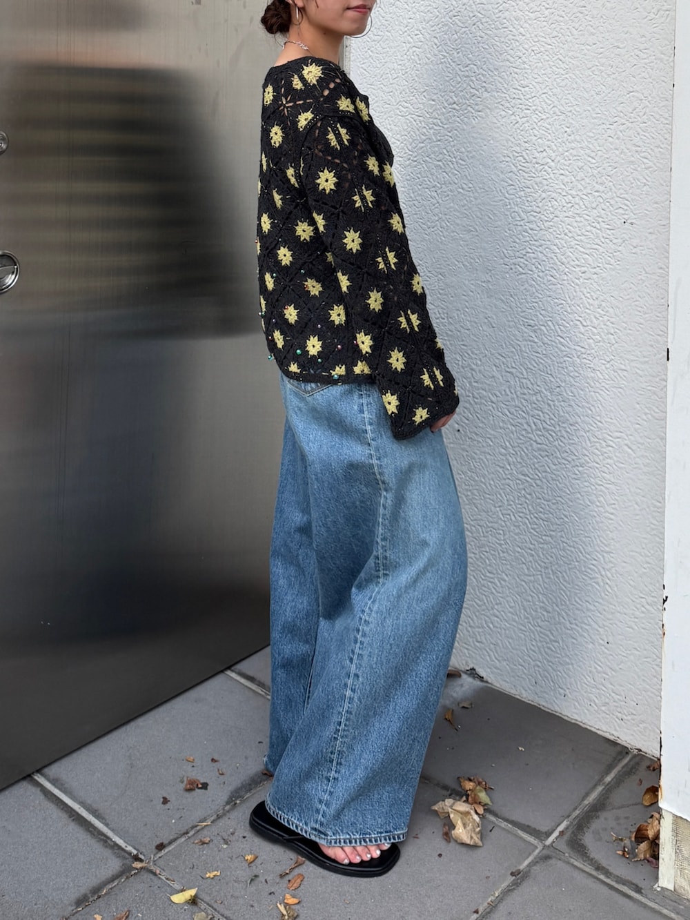 グレー系のカーディガン/ボレロ、ブルー系のデニムパンツ、ブラック系のサンダルを着用したレディースの春コーディネートの3枚目の写真