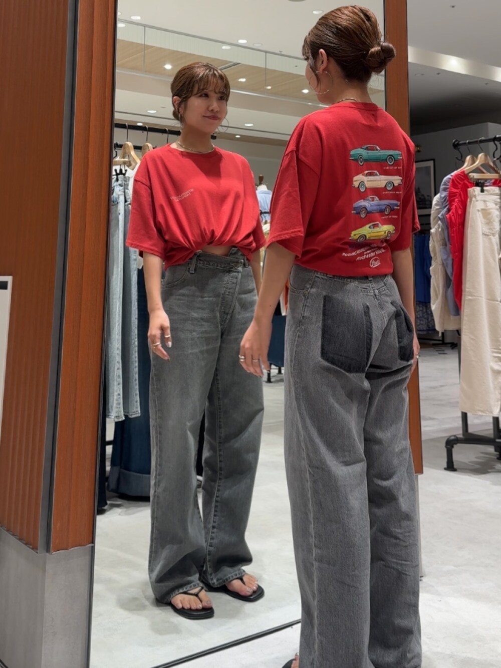 レッド系のTシャツ/カットソー、ブラック系のデニムパンツ、ブラック系のサンダルを着用したレディースの夏コーディネートの7枚目の写真