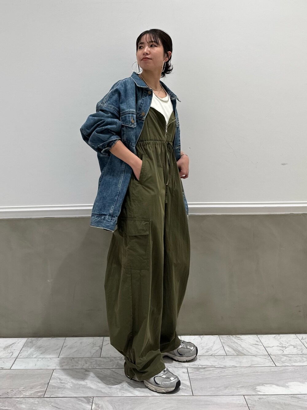 ホワイト系のTシャツ/カットソー、グリーン系のサロペット/オーバーオール、ブルー系のデニムジャケットを着用したレディースの春コーディネートの5枚目の写真