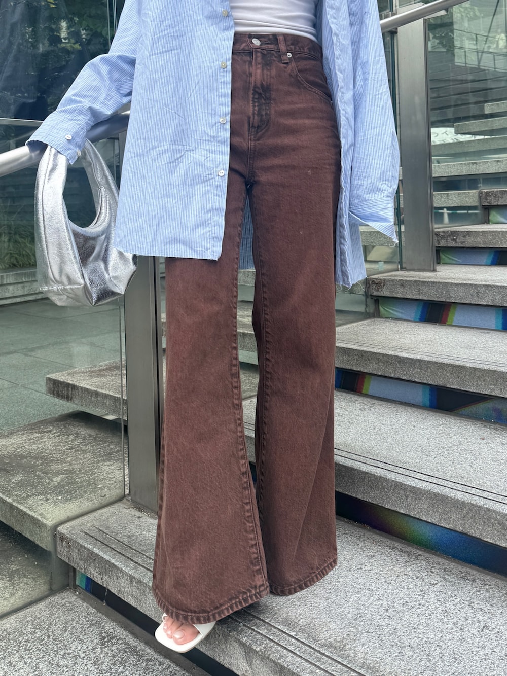 ブラウン系のデニムパンツ、ブルー系のシャツ/ブラウスを着用したレディースの春コーディネートの8枚目の写真