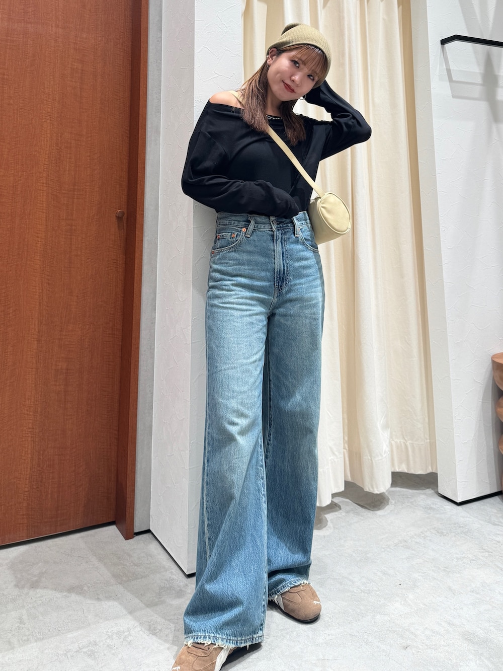 ブルー系のデニムパンツ、ブラック系のTシャツ/カットソー、グリーン系のニットキャップ/ビーニーを着用したレディースの夏コーディネートの5枚目の写真