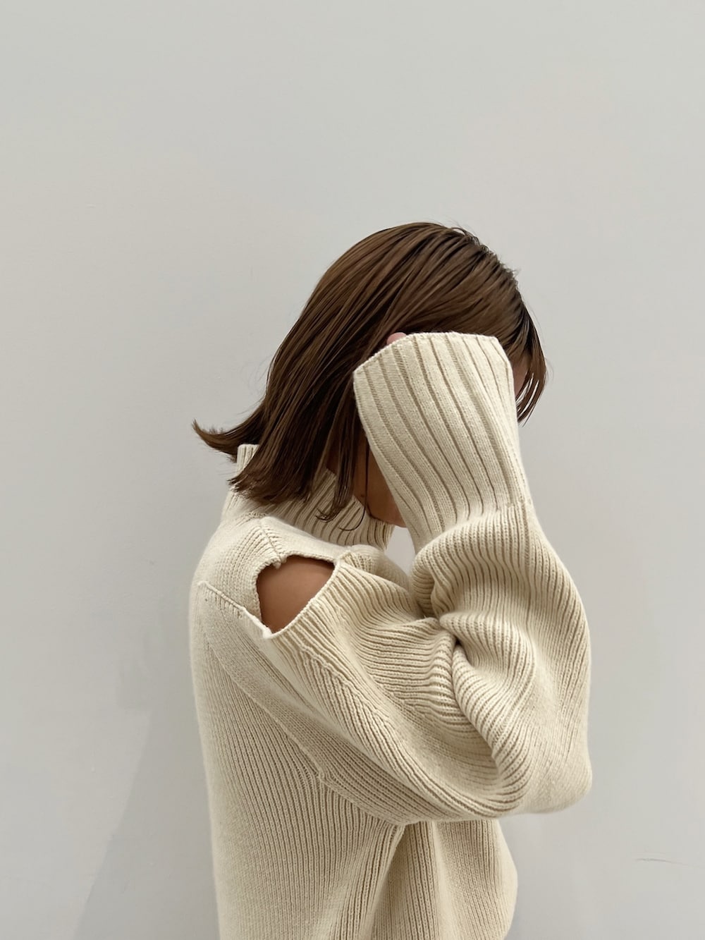 ブラック系のデニムジャケット、ホワイト系のニット/セーター、ブラック系のデニムパンツを着用したレディースの秋コーディネートの6枚目の写真