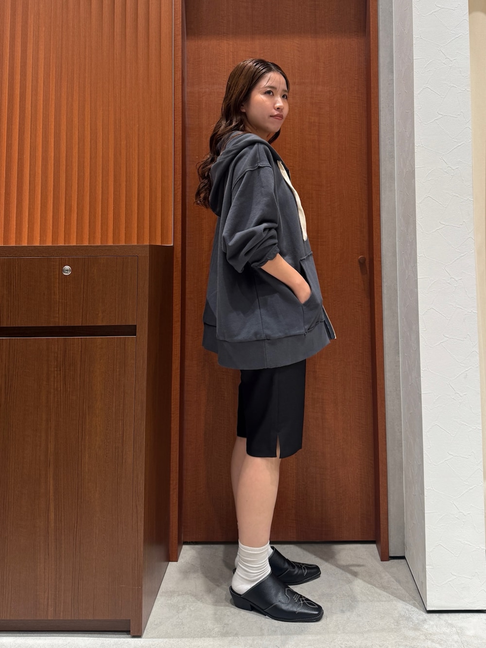 グレー系のパーカー、ブラック系のその他パンツ、ブラック系のその他シューズを着用したレディースの秋コーディネートの2枚目の写真