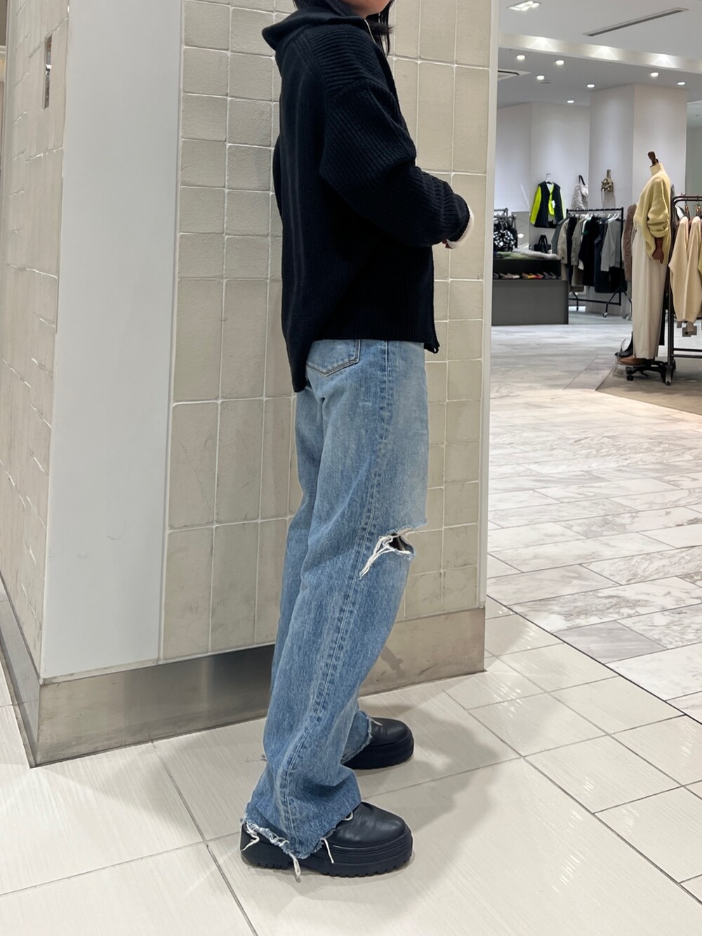 ブルー系のデニムパンツ、ブラック系のカーディガン/ボレロ、ホワイト系のTシャツ/カットソーを着用したレディースの秋コーディネートの4枚目の写真