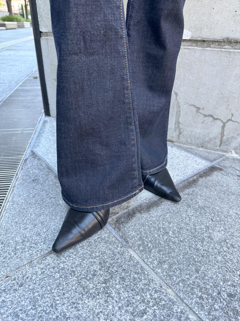 ホワイト系のニット/セーター、ブルー系のデニムパンツ、ブラック系のパンプスを着用したレディースの秋コーディネートの10枚目の写真