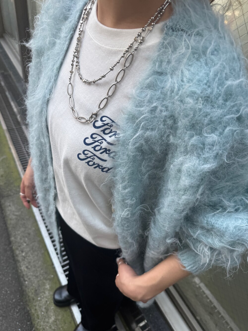 ホワイト系のTシャツ/カットソー、ブラック系のスカート、ブルー系のカーディガン/ボレロを着用したレディースの夏コーディネートの9枚目の写真