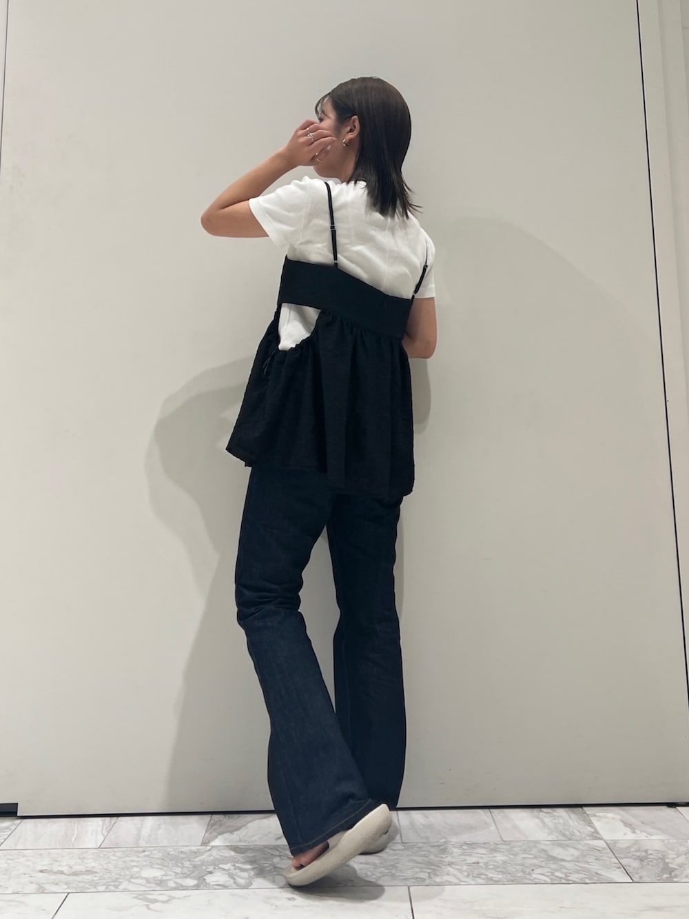 ブルー系のデニムパンツ、ブラック系のキャミソール、ホワイト系のTシャツ/カットソーを着用したレディースの夏コーディネートの4枚目の写真