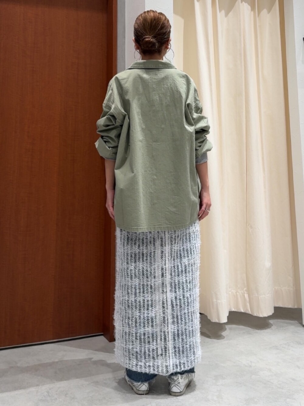 ホワイト系のワンピース、グリーン系のミリタリージャケット、グレー系のTシャツ/カットソーを着用したレディースの春コーディネートの3枚目の写真