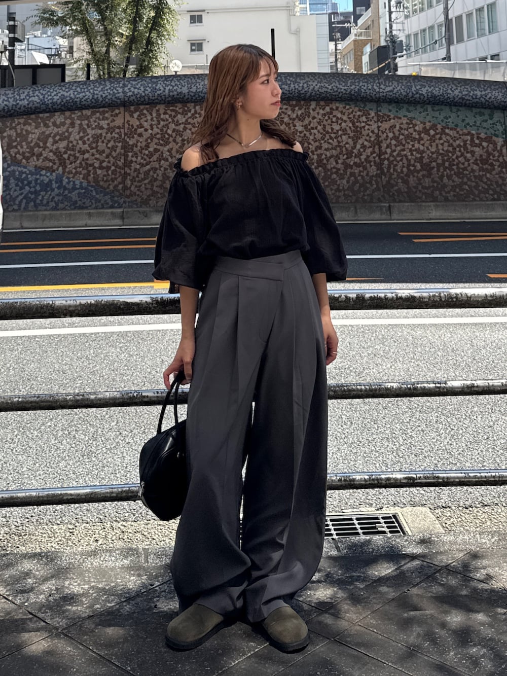 ブラック系のハンドバッグ、ベージュ系のスリッポン、グレー系のその他パンツを着用したレディースの夏コーディネートの3枚目の写真