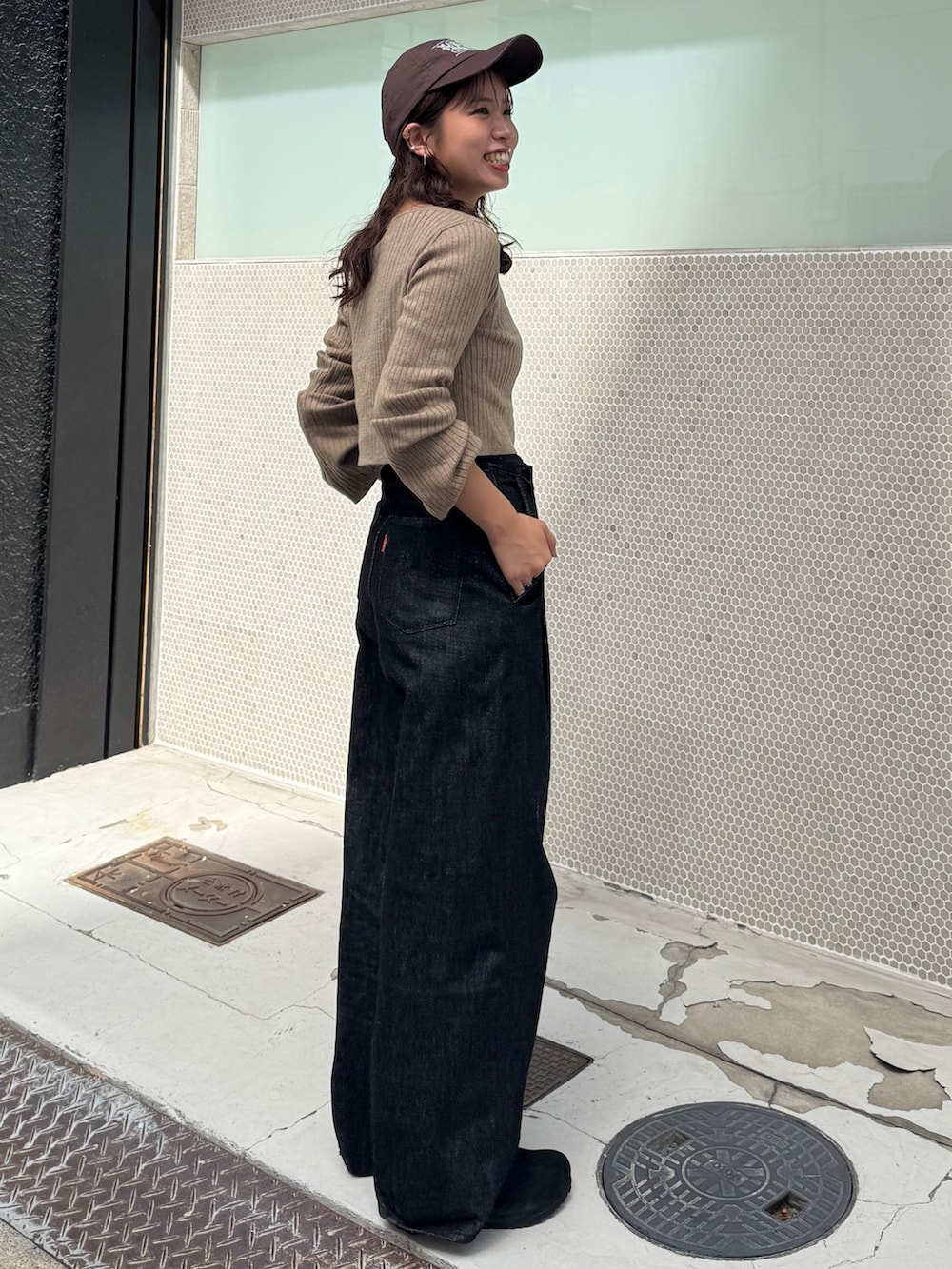 ブラック系のデニムパンツ、グレー系のニット/セーターを着用したレディースの秋コーディネートの6枚目の写真