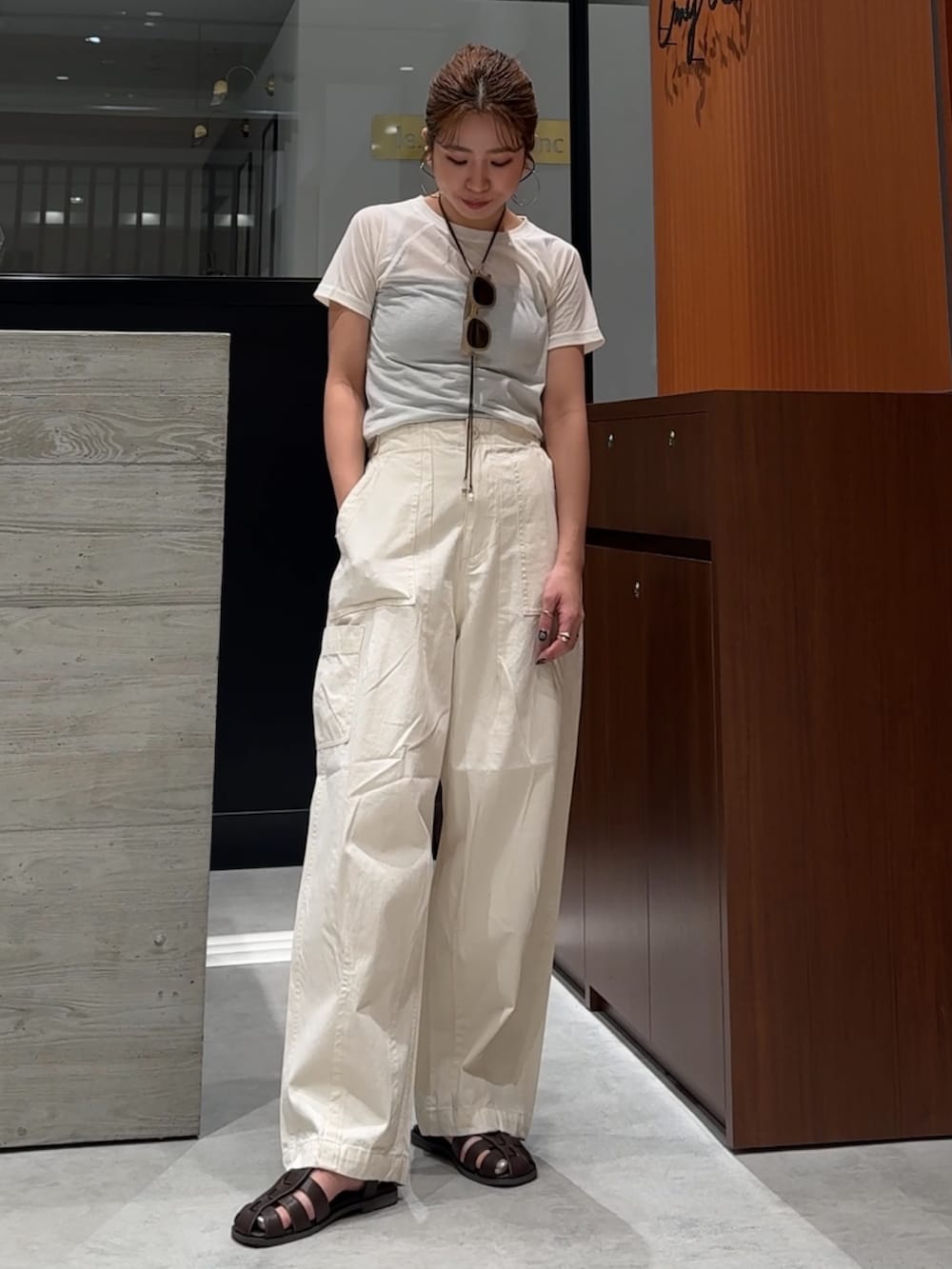 ホワイト系のその他パンツ、ブラウン系のサンダル、ホワイト系のTシャツ/カットソーを着用したレディースの春コーディネートの2枚目の写真