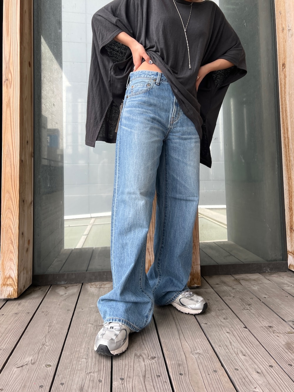 グレー系のTシャツ/カットソー、ブルー系のデニムパンツ、シルバー系のネックレスを着用したレディースの春コーディネートの7枚目の写真
